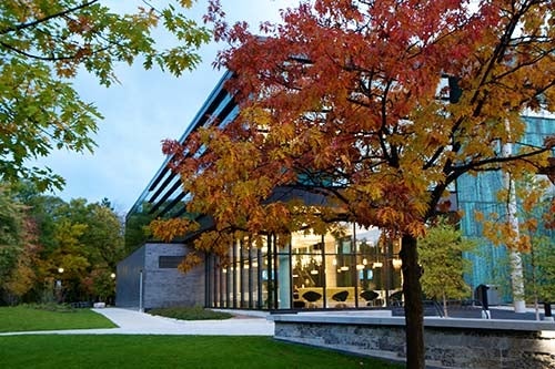 Exterior of U of T Mississauga campus building, surrounded by fall foliage